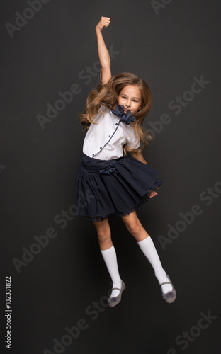 Happy young girl go to first day of school