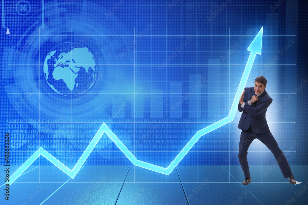 Businessman trying to help economic growth in business concept Businessman trying to help economic growth in business concept