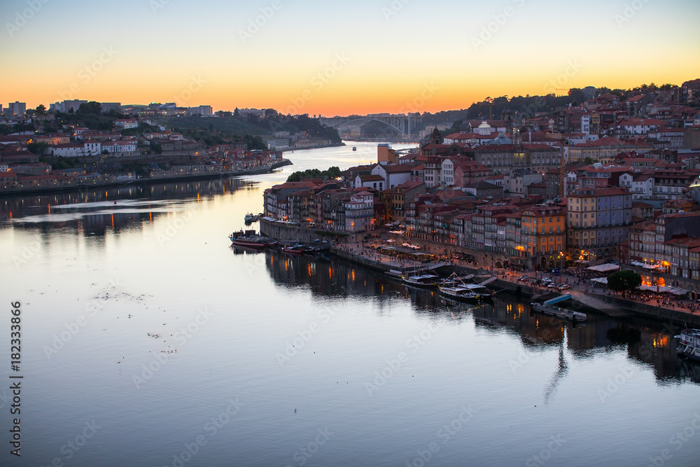 Top view of Douro river and Ribeira promenade at dusk. Porto, Portugal.