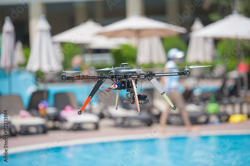 Drone above the pool carbon with camera photo