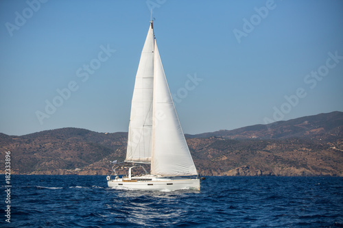 Sailing yacht in the Aegean Sea near the Greek coast.