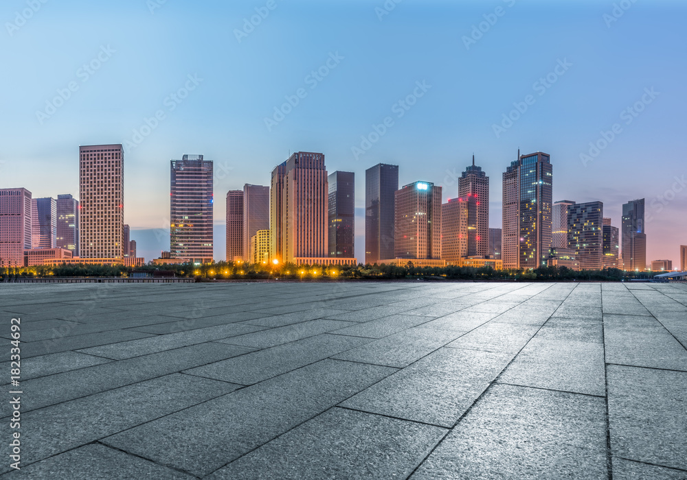 night view of empty brick floor front of modern building