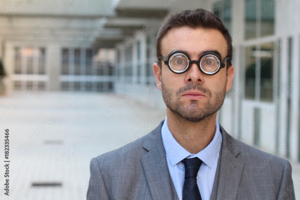 Fototapeta premium Foolish geek looking stunned in the office
