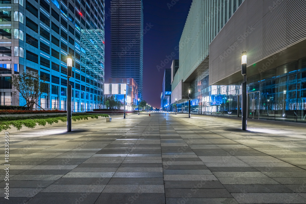 night view of empty brick floor front of modern building night view of empty brick floor front of modern building
