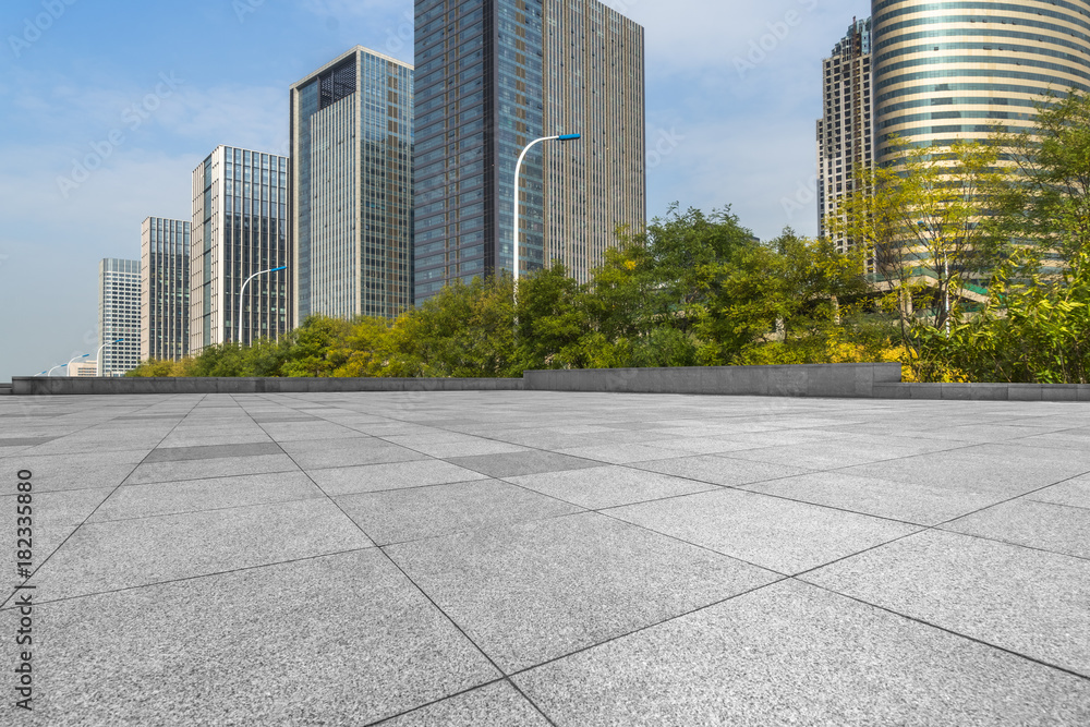 empty pavement and modern buildings in city.