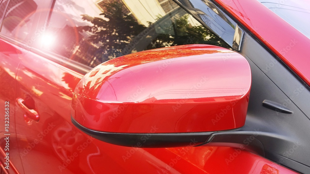 Naklejka side rear-view mirror on a red modern car