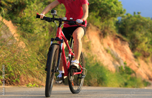 woman cyclist cycling mountain bike on trail