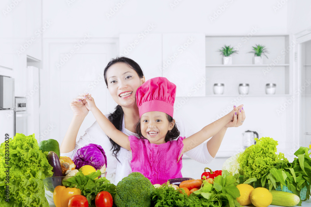 Mother and daughter with healthy vegetable Mother and daughter with healthy vegetable