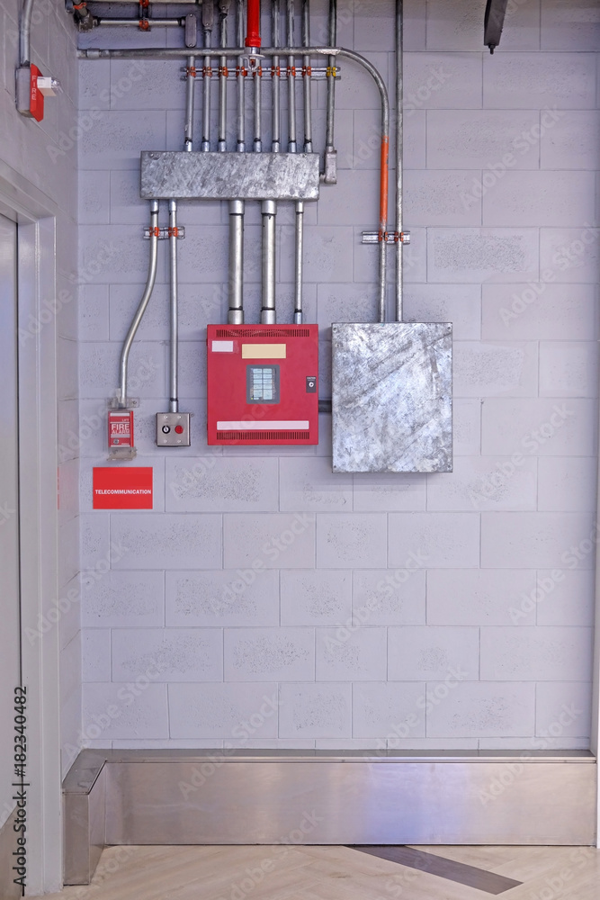 fire alarm switch on wall. Electrical Conduit & PVC Conduit Stock Photo