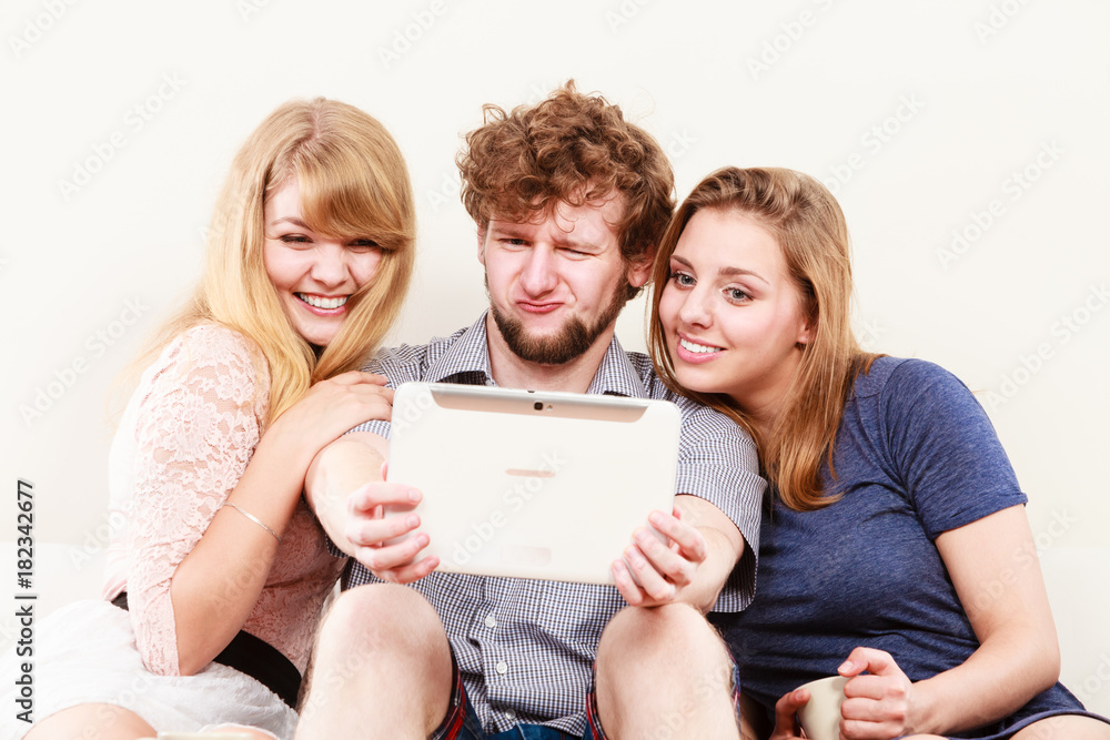 Friends relaxing browsing internet on tablet. Friends relaxing browsing internet on tablet.