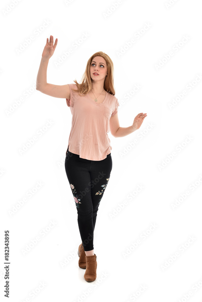 full length portrait of a girl wearing pink shirt and black floral pants. standing pose, isolated on white background. full length portrait of a girl wearing pink shirt and black floral pants. standing pose, isolated on white background.