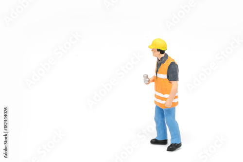 Miniature people worker safety construction concept on white background with a space for text © pigprox