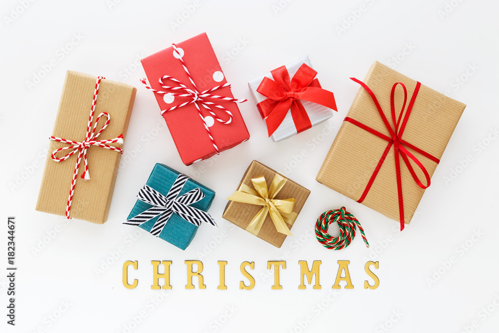 Christmas gift boxes with christmas word on white background flat lay