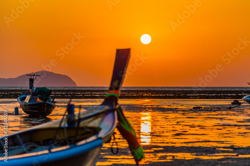 the red sun on the head of fishing boat photo