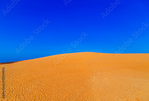 amazing sand dune fields desert landscape with blue sky. Dunes background dry regions
