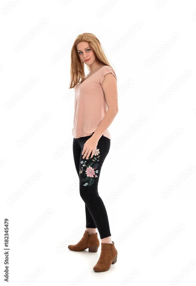full length portrait of a girl wearing pink shirt and black floral pants. standing pose, isolated on white background. full length portrait of a girl wearing pink shirt and black floral pants. standing pose, isolated on white background.