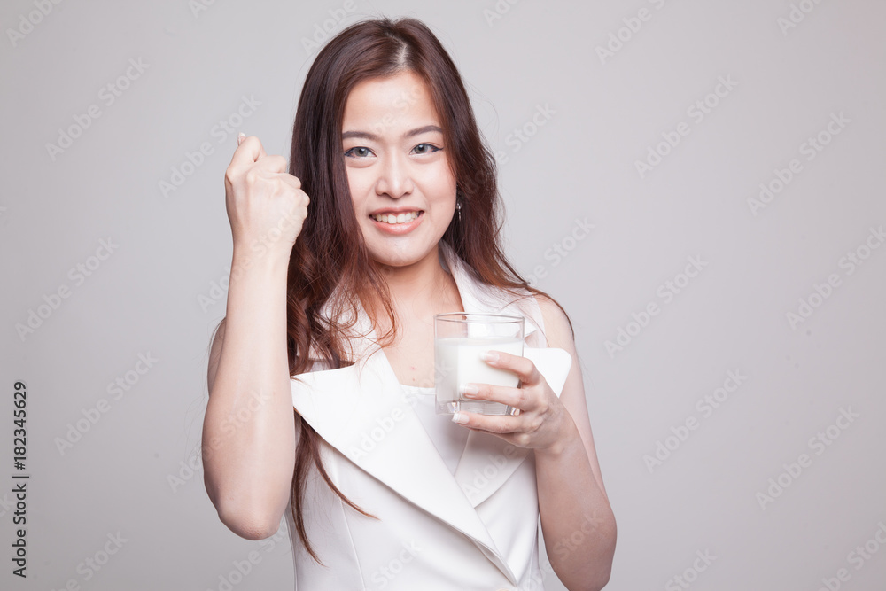 Healthy Asian woman drinking a glass of milk. Healthy Asian woman drinking a glass of milk.