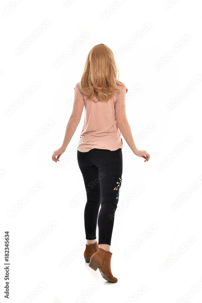 full length portrait of a girl wearing pink shirt and black floral pants. standing pose, isolated on white background. full length portrait of a girl wearing pink shirt and black floral pants. standing pose, isolated on white background.