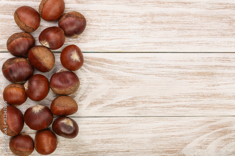 chestnut on white wooden background with copy space for your text. Top view. Flat lay. chestnut on white wooden background with copy space for your text. Top view. Flat lay.