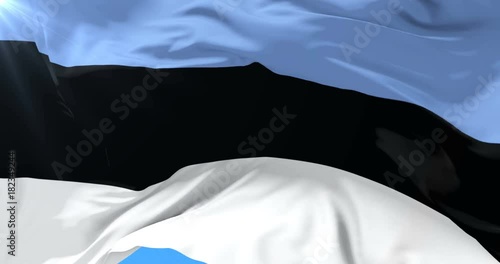 Estonian flag waving at wind with blue sky in slow, loop photo