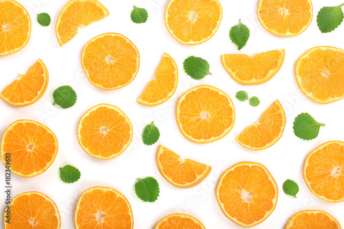 Slices of orange or tangerine with mint leaves isolated on white background. Flat lay, top view. Fruit composition