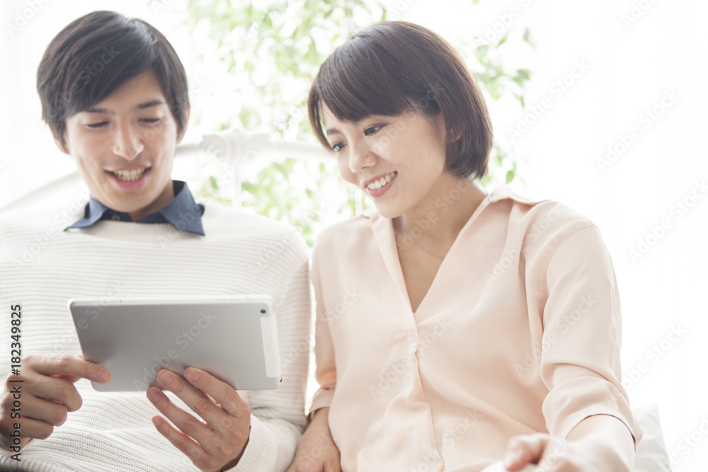 A couple is using a tablet terminal. A couple is using a tablet terminal.