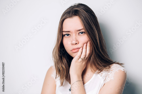unhappy woman feel pain on her teeth isolated on white background,