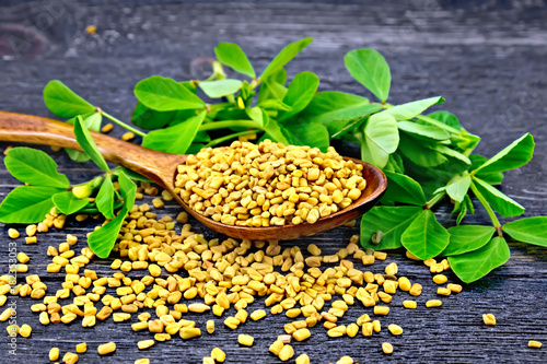 Fenugreek with leaf in spoon on board
