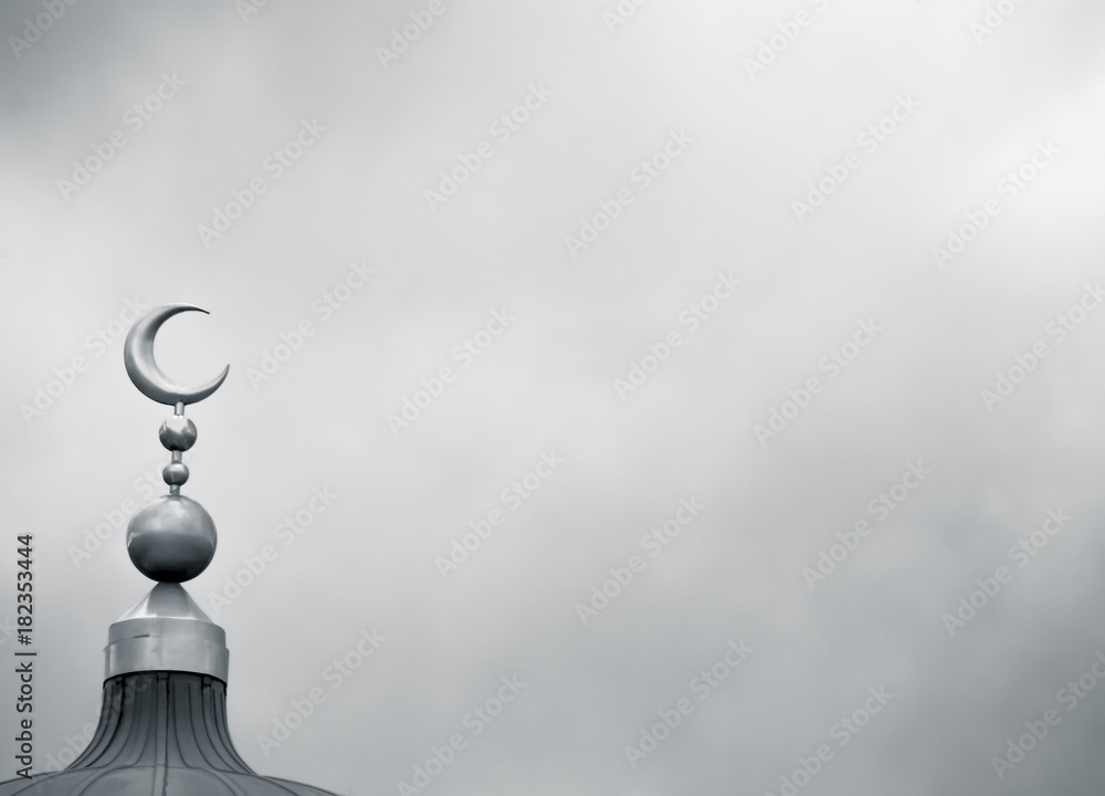 Islamic symbol on mosque in overcast weather