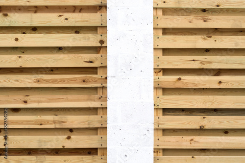 White pillar and background of wooden horizontal slats