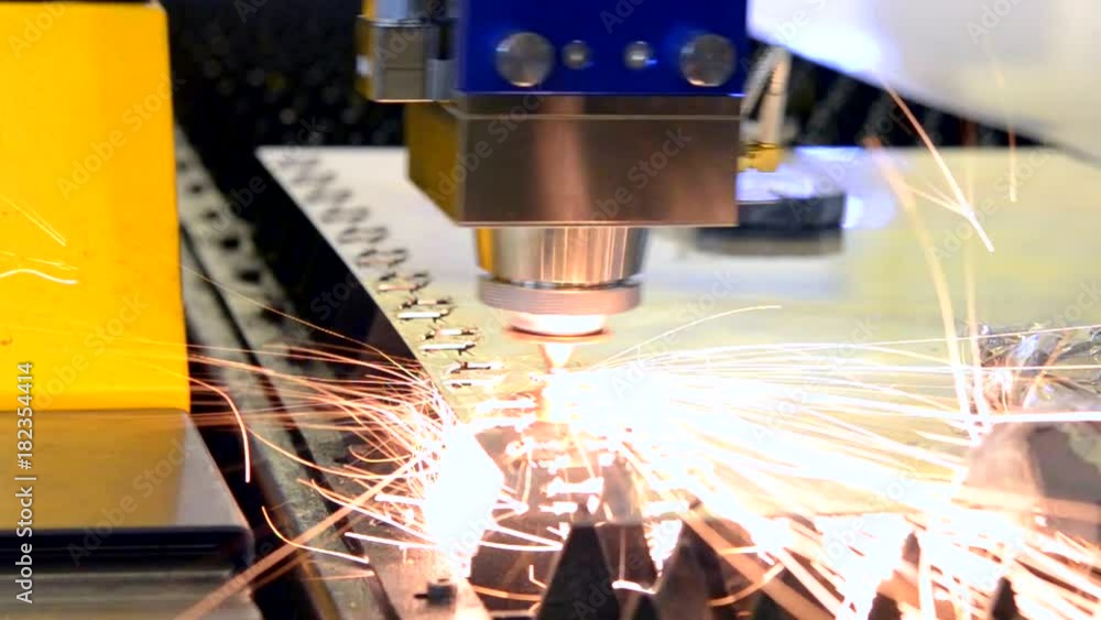 Fiber laser machines for metal cutting close-up. A laser beam cuts the sheet metal in the manufacture. Industrial technologies, production processes