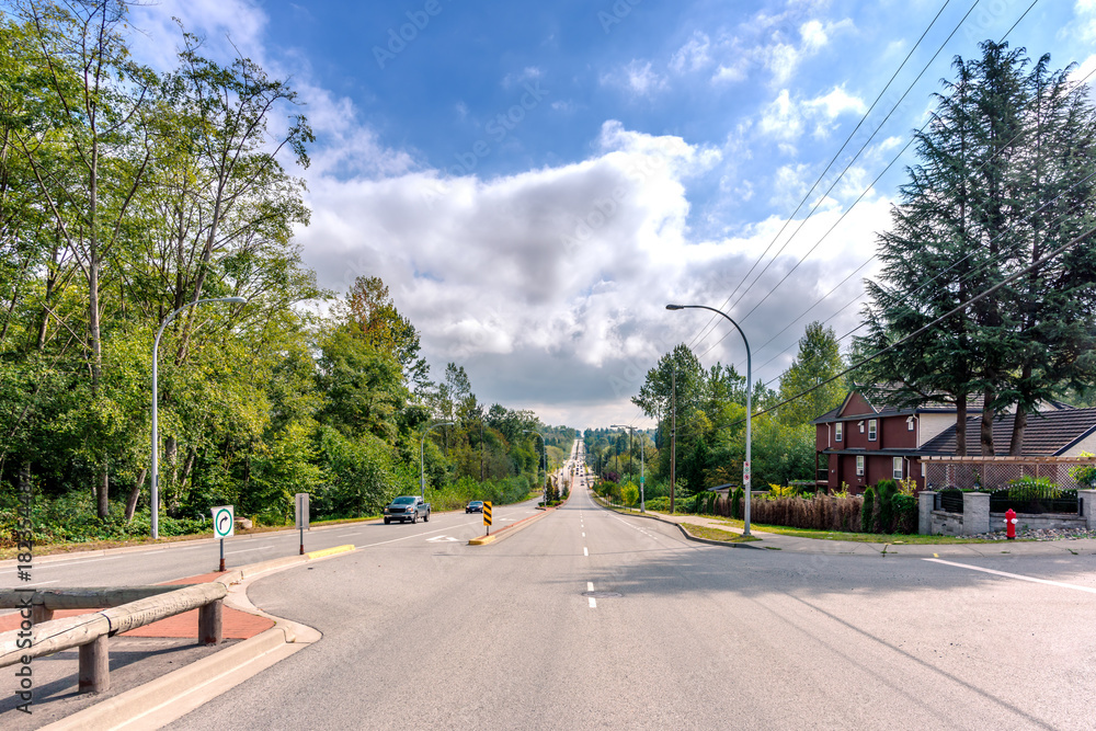 Naklejka premium Cars go on the road on the outskirts of the city, in the suburbs