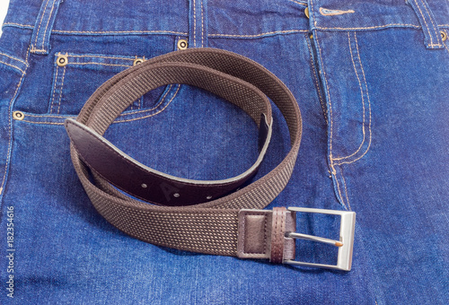 Brown elastic stretch belt on a blue jeans