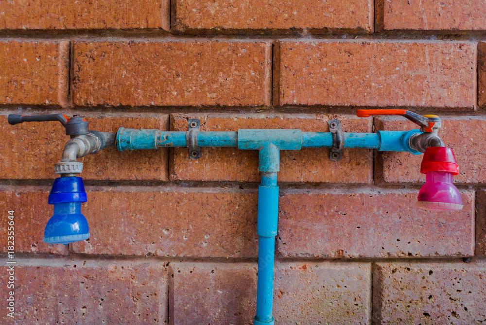 Close up of old faucet on tile for background, Old tap water, old faucet on concrete wall, save the water concep Close up of old faucet on tile for background, Old tap water, old faucet on concrete wall, save the water concep