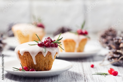 Christmas mini cake with sugar icing, cranberries and rosemary