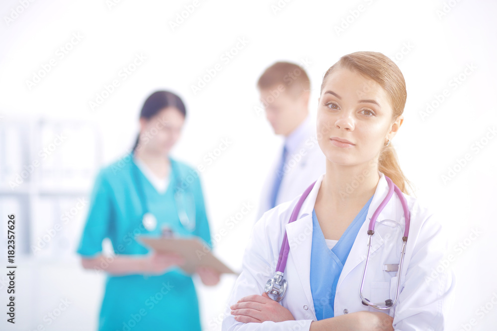 Attractive female doctor in front of medical group. Attractive female doctor in front of medical group.
