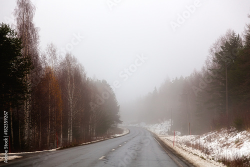 A deserted highway is in the fog © tenrec