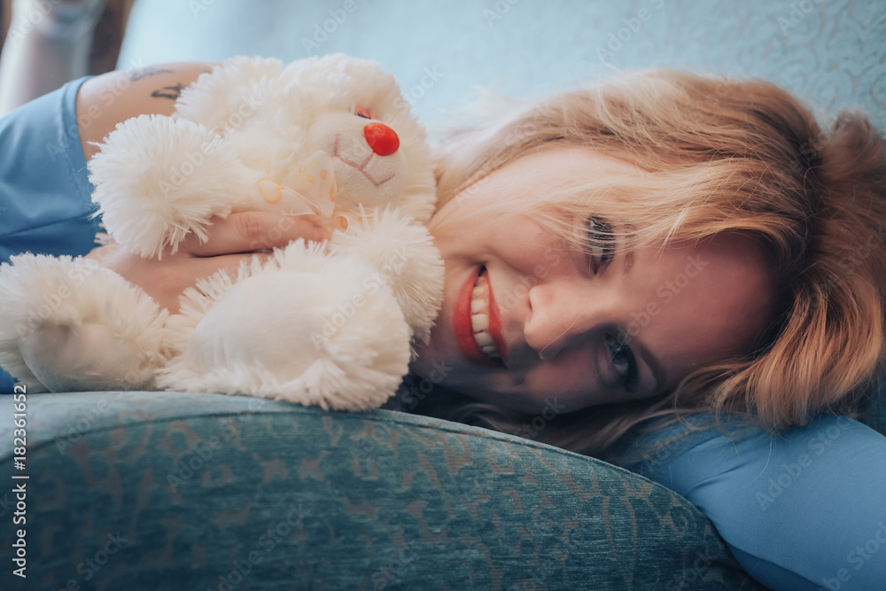 Blond woman in blue dress in cafe