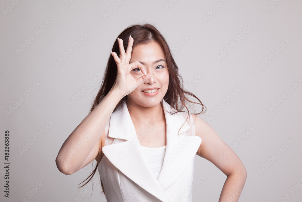 Beautiful young Asian woman show OK sign over her eye. Beautiful young Asian woman show OK sign over her eye.