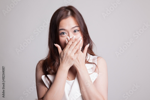 Beautiful young Asian woman close her mouth.