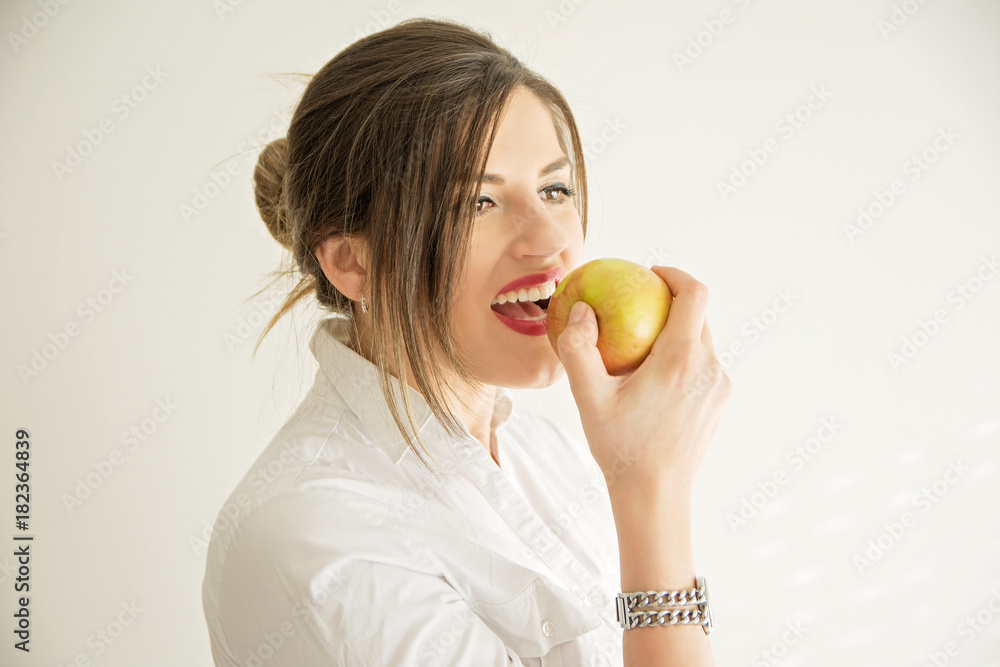 Beautiful woman with pearly white and healthy teeth eating apple Beautiful woman with pearly white and healthy teeth eating apple