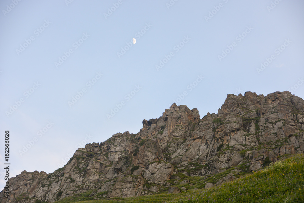 Rocky against blue sky and beautiful crescent in evening Rocky against blue sky and beautiful crescent in evening