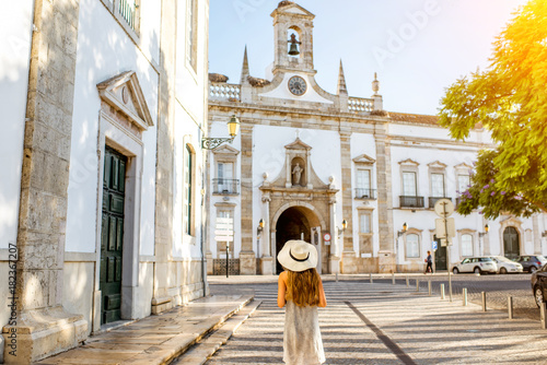 Young woman in hat in front of church, Faro, Portugal photo