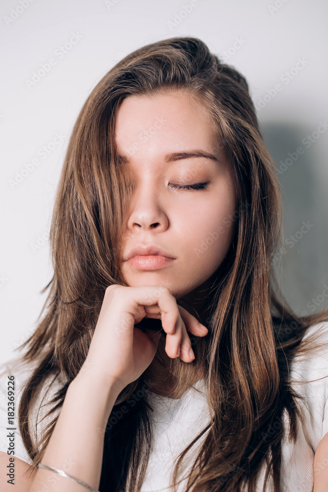 Close up girl. eyes closed. Beautiful woman in white t-shirt, brooding Close up girl. eyes closed. Beautiful woman in white t-shirt, brooding