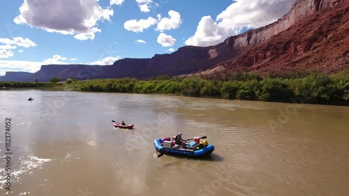 Aerial of family floating down colorado river in dry utah desert