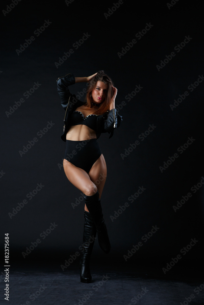 Fototapeta premium Image of woman with hands behind head in boots