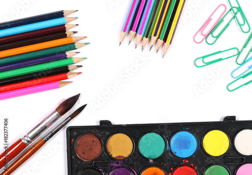 Watercolor pallet, wooden color pencils and brush set for painting, isolated on white background, top view