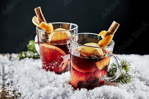 Tasty mulled red wine with orange and cinnamon photo