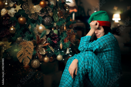 Obraz na plátně Sad Upset Lonely Girl Crying Next to Her Christmas Tree