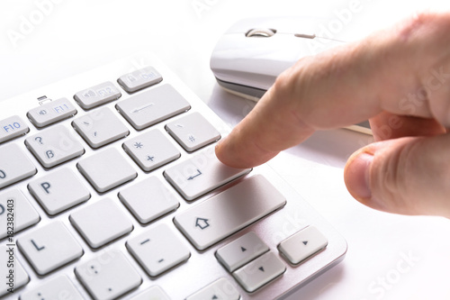 Pressing enter button on the computer keyboard photo